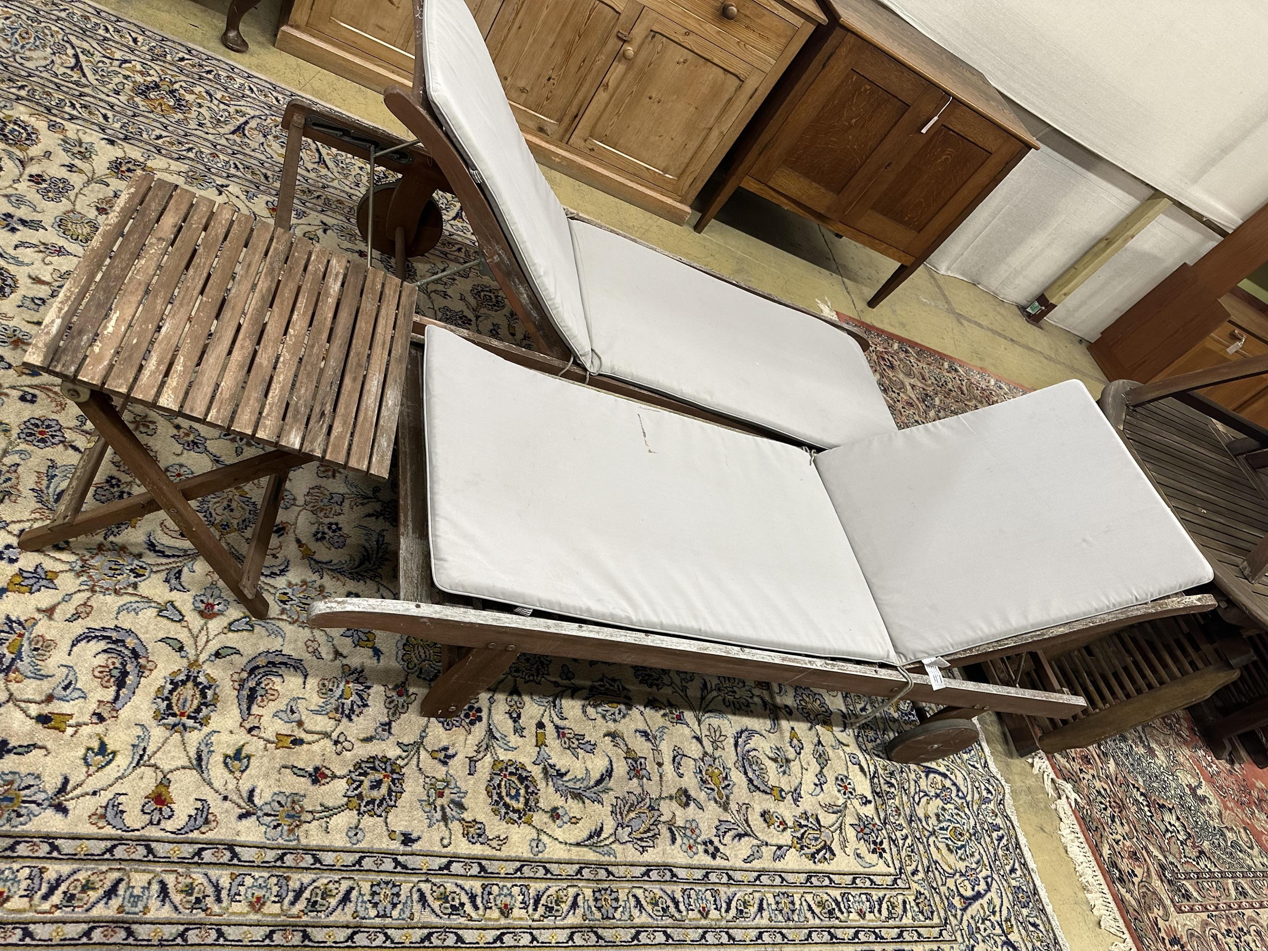 A pair of John Lewis weathered teak garden loungers and a folding occasional table. Condition - fair